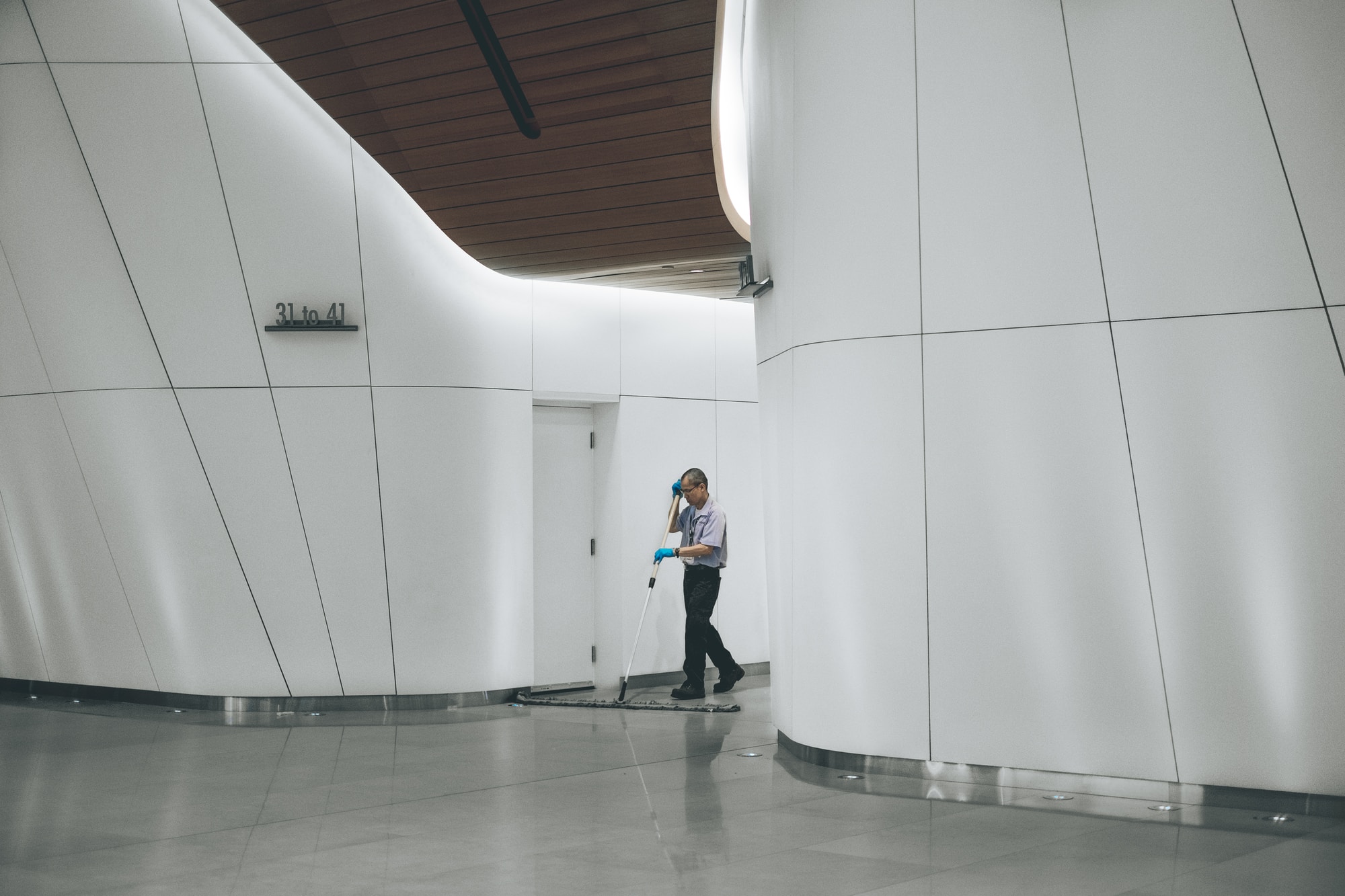 man cleaning reception area of office