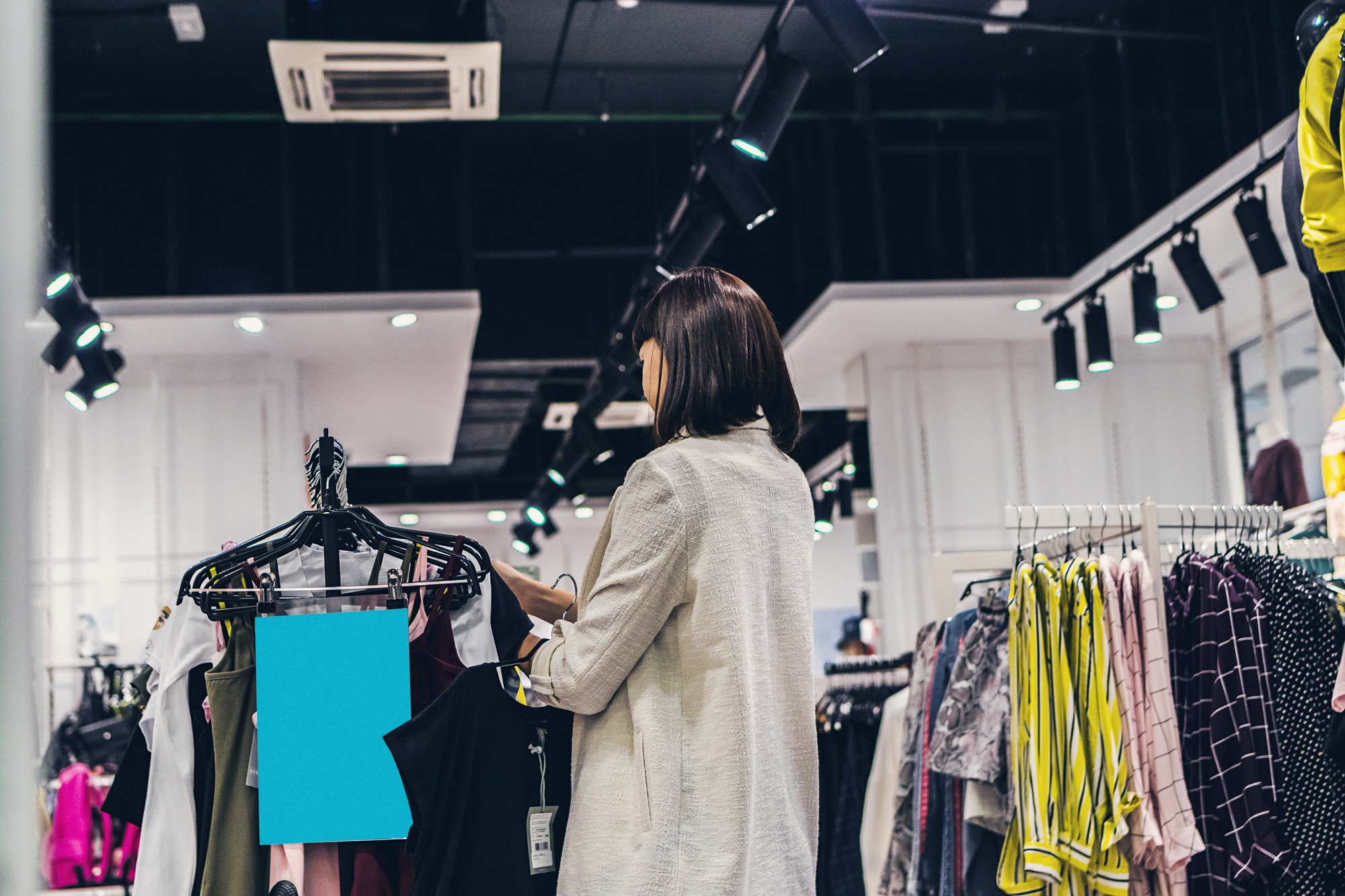 woman browsing clothing in shop