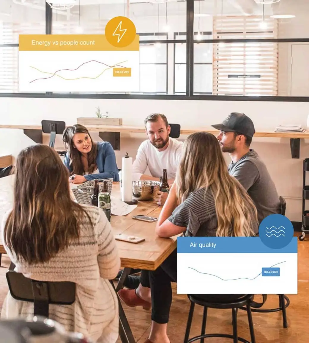 People sitting around desk working and talking People sitting around desk working and talking